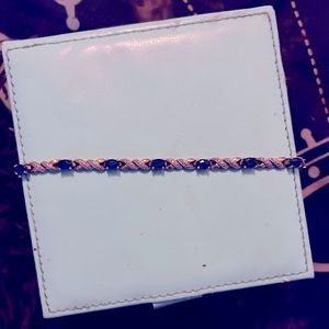 A woman’s emerald diamond tennis bracelet